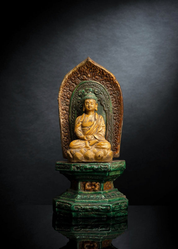A sancai-glazed pottery figure of seated Buddha on a throne, Wanli period, dated by inscription 1584