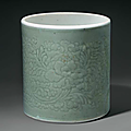 A celadon-glazed carved cylindrical brush pot, china, qing dynasty, kangxi period (1662-1722) 