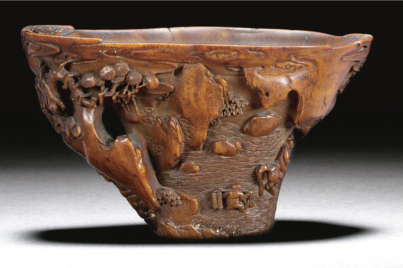 A rhinoceros horn 'landscape' libation cup, Qing dynasty, Kangxi period (1662-1722)
