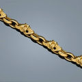 An eighteen karat gold skull motif link bracelet, bill wall & a charm bracelet