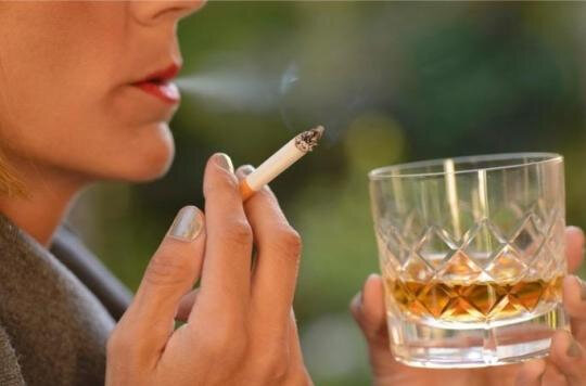 uploded_woman-drinking-a-glass-of-whiskey-and-smoking-a-cigarette-picture-id902089248-1545995481