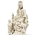 A dehua group of a seated guanyin and two attendants, late ming dynasty, circa 1640