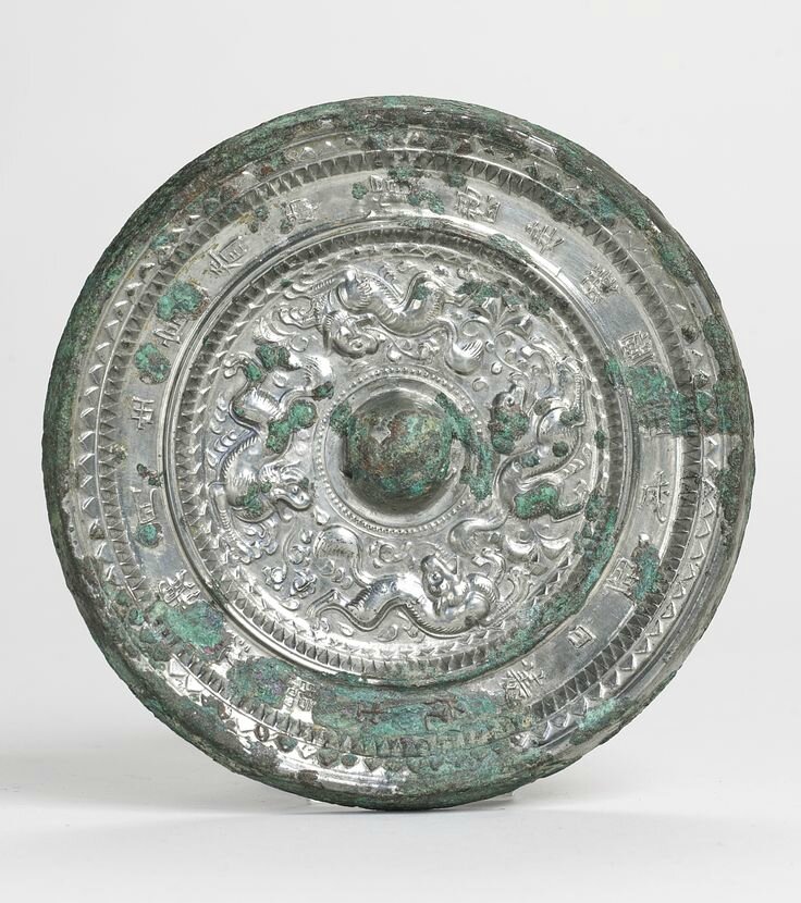 A bronze 'mythical Beasts' mirror with inscription, Sui-Early Tang dynasty 
