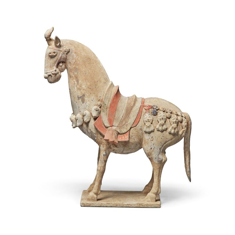 A painted pottery figure of a caparisoned horse, Northern Qi dynasty