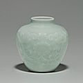A rare small relief-decorated celadon-glazed jar. qianlong seal mark in underglaze blue and of the period (1736-1795)