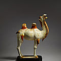 A magnificent amber and straw-glazed pottery figure of a Bactrian camel, Tang Dynasty