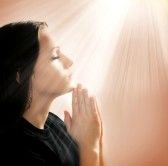 11936321-woman-praying-with-lights-shining-down