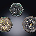 Three miniature silver-decorated bronze floriform mirrors, tang dynasty (618-907)