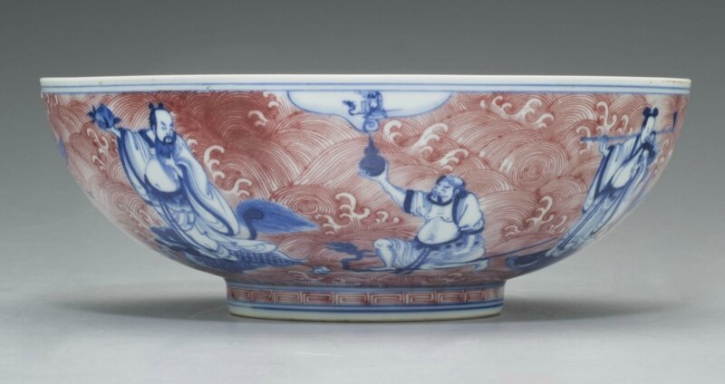 An underglaze blue and copper-red 'Immortals' bowl, Qianlong six-character seal mark in underglaze blue and of the period (1736-1795)