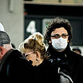 1297171-france-travellers-with-mouth-masks-against-the-coronavirus-at-the-aeroport