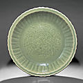 A fine and rare large longquan celadon barbed 'peony' dish, early ming dynasty, late 14th-early 15th century